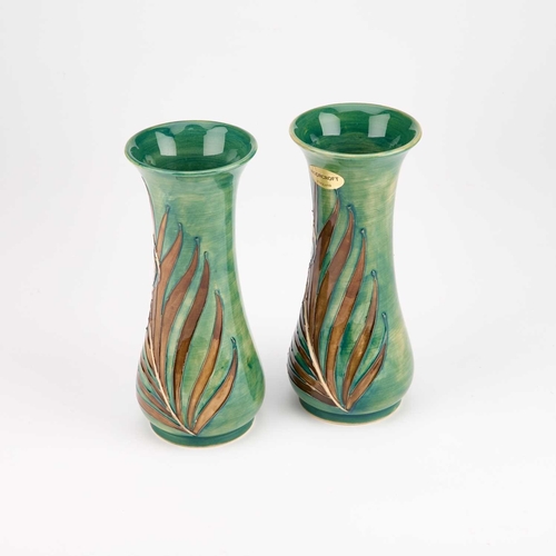 65 - A PAIR OF MOORCROFT POTTERY VASES, DESIGNED BY SALLY TUFFIN FOR LIBERTY & CO tubelined and hand-pain... 