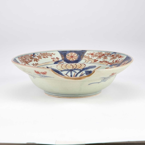 80 - A JAPANESE IMARI PORCELAIN BARBER'S BOWL, 18TH CENTURY of circular form, typically painted with a ja... 