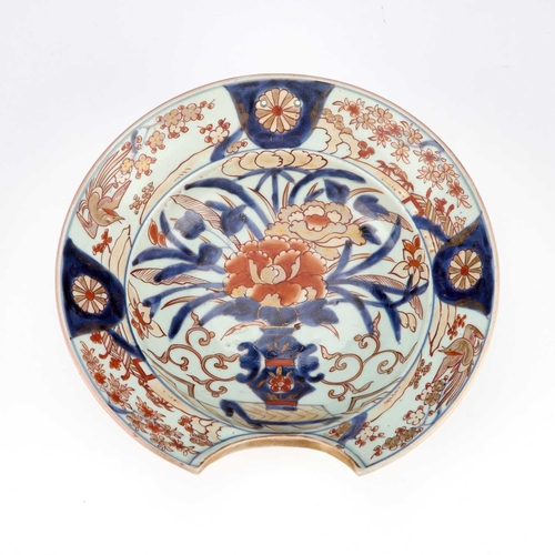 80 - A JAPANESE IMARI PORCELAIN BARBER'S BOWL, 18TH CENTURY of circular form, typically painted with a ja... 