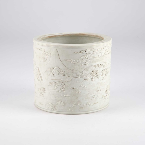 86 - A CHINESE CARVED BISCUIT PORCELAIN BRUSH POT cylindrical, decorated with a battle scene and fortress... 