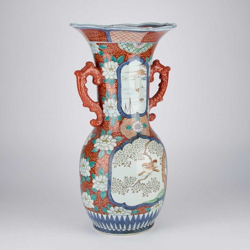 89 - A JAPANESE IMARI PORCELAIN ALCOVE VASE Meiji period, the trumpet neck with twin handles, the baluste... 