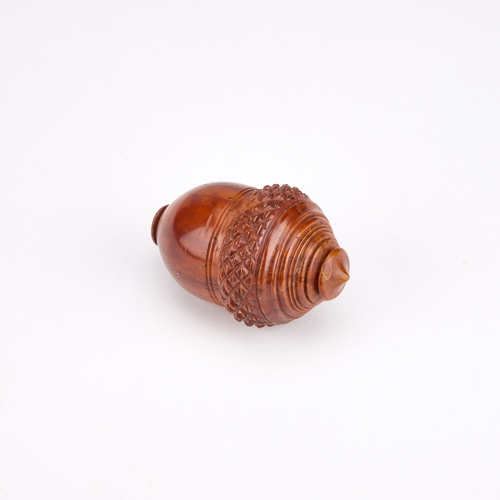 127 - A 19TH CENTURY COQUILLA NUTMEG GRATER in the form of an acorn. 7cm high