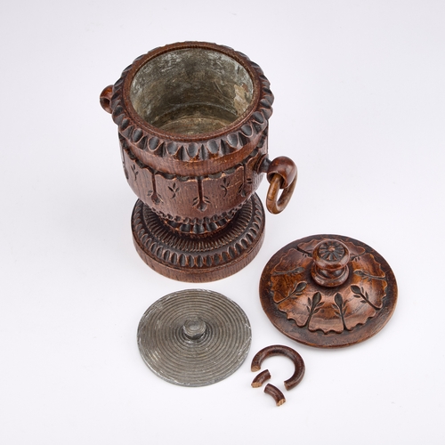 169 - A 19TH CENTURY CARVED OAK TOBACCO JAR AND COVER 23cm high