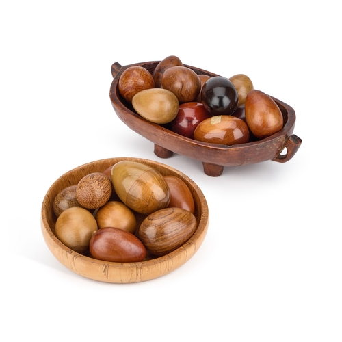 224 - A COLLECTION OF TREEN EGGS AND TWO TREEN BOWLS turned from various woods, two of the eggs nesting eg... 