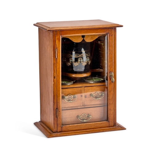 233 - AN EDWARDIAN OAK SMOKERS CABINET the interior with a tobacco jar and pair of ashtrays. 39.5cm high... 