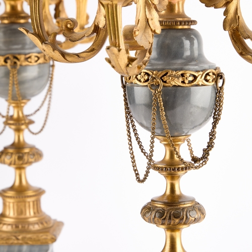 299 - A PAIR OF LOUIS XVI STYLE GREY MARBLE AND ORMOLU FIVE-LIGHT CANDELABRA each with four scroll-form le... 