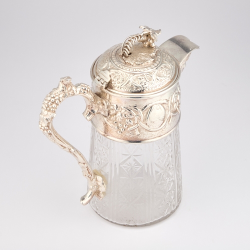 329 - A LARGE SILVER-PLATE MOUNTED CUT-GLASS CLARET JUG by James Dixon & Sons, the mount chased with f... 