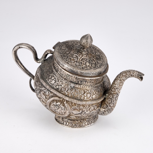 334 - AN INDAN KASHMIRI SILVER TEAPOT of tipped kang form, chased Kutch pattern with segments and floral f... 