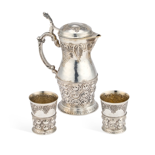 395 - A LATE 19TH CENTURY GERMAN SILVER JUG AND BEAKERS SET Hanau marks, the jug of baluster form with a h... 