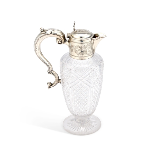 452 - AN EDWARDIAN SILVER-MOUNTED CUT-GLASS CLARET JUG by William Devenport, Birmingham 1904, with a leaf-... 