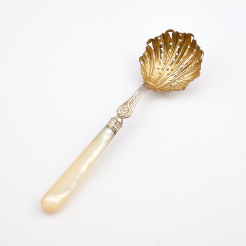 539 - A VICTORIAN SILVER SIFTING SPOON maker's mark rubbed, London 1884, with a mother-of-pearl handle and... 