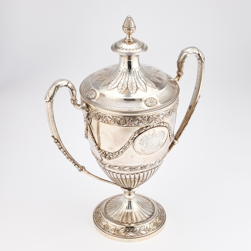 598 - A GEORGE III SILVER-GILT TWO-HANDLED CUP AND COVER by William Holmes, London 1801, the trophy in the... 