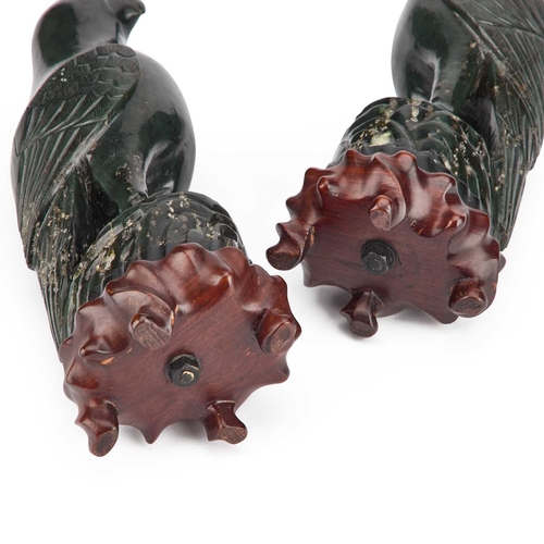 1005 - A PAIR OF CHINESE SPINACH GREEN JADE MODELS OF BIRDS the birds 19th Century or earlier, the wooden s... 