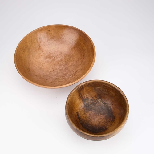 104 - A SYCAMORE DAIRY BOWL, CIRCA 1900 together with a smaller treen bowl. (2) First 30cm diameter