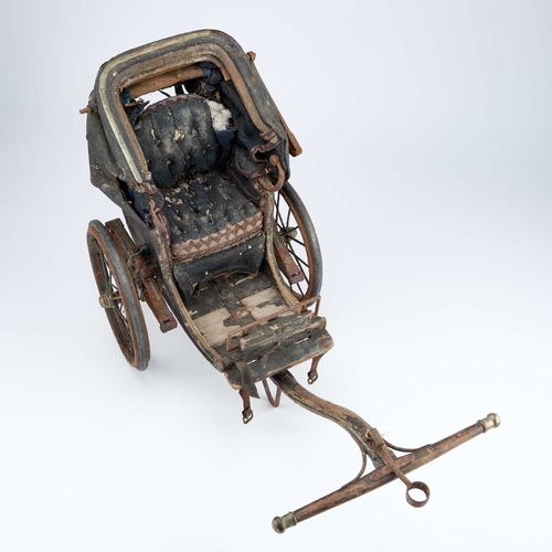 1057 - A VICTORIAN MINIATURE CART with an upholstered seat and folding canopy. 67cm long overall