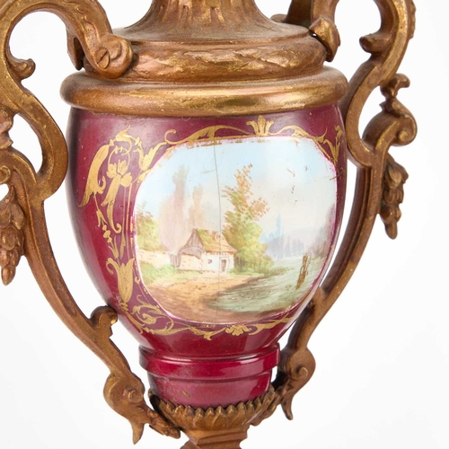 1246 - A LATE 19TH CENTURY FRENCH GILT-METAL AND MAGENTA-GROUND PORCELAIN CLOCK GARNITURE the clock elabora... 