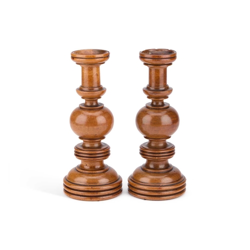 126 - A PAIR OF 19TH CENTURY TREEN CANDLESTICKS each with a bulbous knopped stem. (2) 22.5cm high