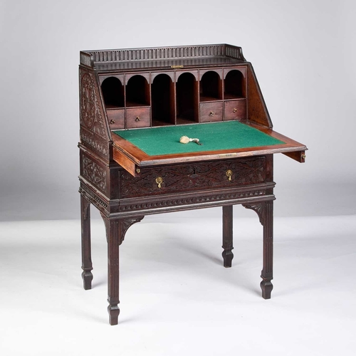 1271 - A 19TH CENTURY CARVED OAK BUREAU ON STAND the slant-front opening to reveal a fitted interior, the s... 