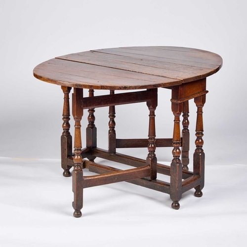 1291 - AN 18TH CENTURY OAK GATELEG DINING TABLE raised on block and baluster legs; together with four early... 