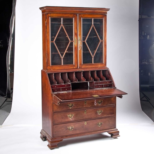 1313 - A GEORGE III MAHOGANY BUREAU BOOKCASE the upper section with dentil cornice and astragal moulded doo... 