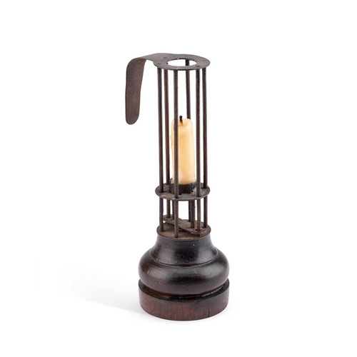 134 - AN EARLY 19TH CENTURY FRENCH WROUGHT IRON AND WOODEN BIRDCAGE OR STABLE CANDLESTICK 25cm high