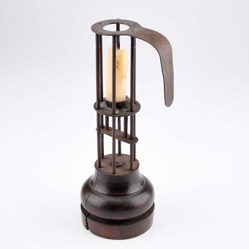 134 - AN EARLY 19TH CENTURY FRENCH WROUGHT IRON AND WOODEN BIRDCAGE OR STABLE CANDLESTICK 25cm high