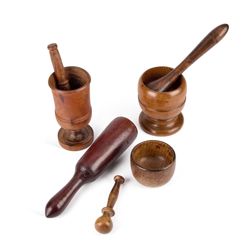 220 - A GROUP OF TREEN PESTLE AND MORTARS including a large mahogany pestle, etc. (Qty)General wear, some ... 