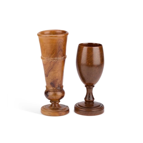 282 - TWO TREEN GOBLETS the first with a tapering cylindrical bowl, the second with an ovoid bowl. (2) Tal... 