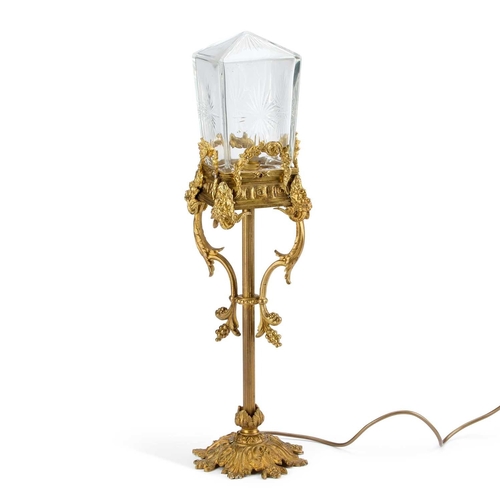 294 - A GILT-METAL AND CUT-GLASS TABLE LAMP the square-section shade with a pointed domed top, the sides s... 