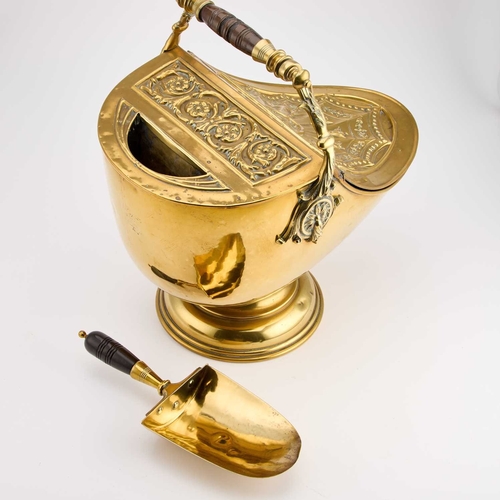 302 - A GOOD VICTORIAN BRASS COAL BUCKET helmet-shaped, complete with the original shovel, the handle with... 