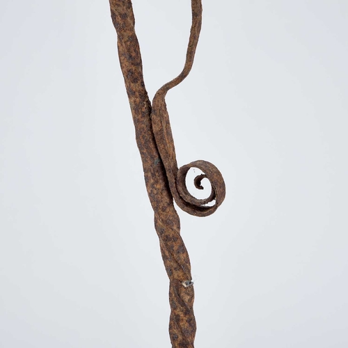 306 - A 19TH CENTURY WROUGHT IRON RUSH-NIP HOLDER raised on three feet. 68.8cm high