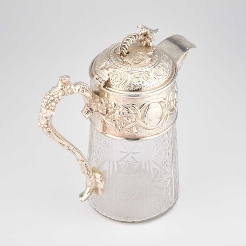 329 - A LARGE SILVER-PLATE MOUNTED CUT-GLASS CLARET JUG by James Dixon & Sons, the mount chased with f... 