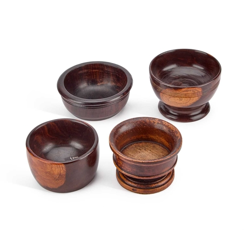 42 - TWO 19TH CENTURY LIGNUM VITAE BOWLS together with a turned salt and a bowl. (4) Widest 10.5cm