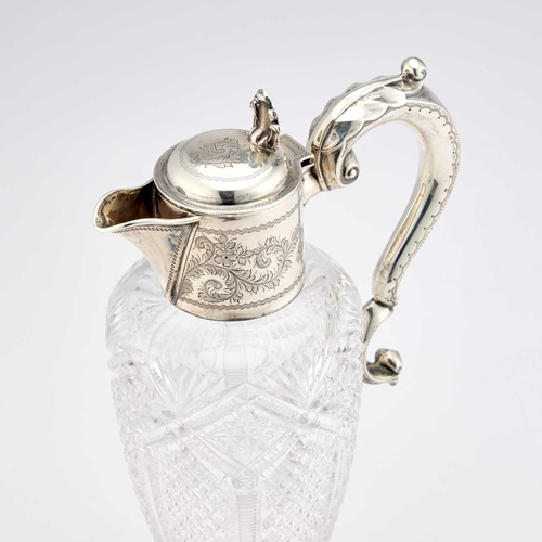 452 - AN EDWARDIAN SILVER-MOUNTED CUT-GLASS CLARET JUG by William Devenport, Birmingham 1904, with a leaf-... 