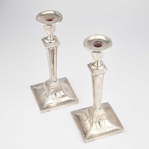 460 - A PAIR OF NEOCLASSICAL REVIVAL SILVER CANDLESTICKS by Hawksworth, Eyre & Co Ltd, Sheffield 1904,... 