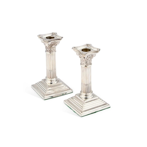 478 - A PAIR OF EDWARDIAN SILVER CORINTHIAN COLUMN CANDLESTICKS by Levi & Salaman, Birmingham 1904, ea... 