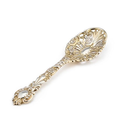 506 - A VICTORIAN SILVER-GILT SERVING SPOON by Charles Edwards, London 1900, the pierced bowl chased with ... 