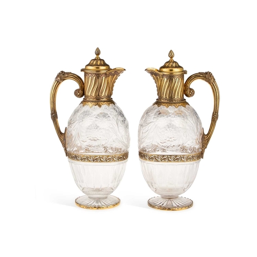 514 - A FINE PAIR OF EDWARDIAN SILVER-GILT MOUNTED STOURBRIDGE 'ROCK CRYSTAL' GLASS CLARET JUGS by Hunt &a... 