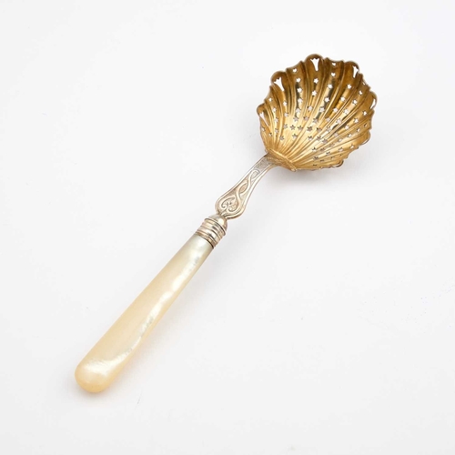 539 - A VICTORIAN SILVER SIFTING SPOON maker's mark rubbed, London 1884, with a mother-of-pearl handle and... 