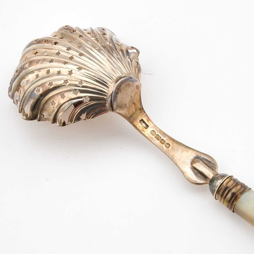 539 - A VICTORIAN SILVER SIFTING SPOON maker's mark rubbed, London 1884, with a mother-of-pearl handle and... 