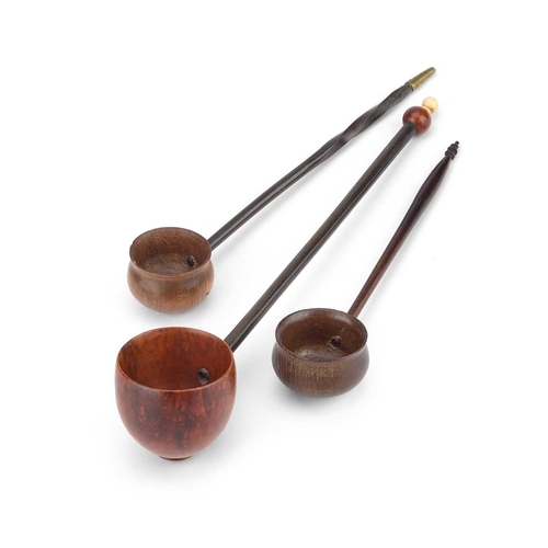 72 - Â§ A COLONIAL COQUILLA NUT TREEN TODDY LADLE together with two further treen toddy ladles, one with ... 