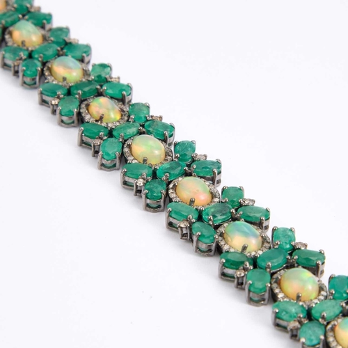 723 - AN OPAL, EMERALD AND DIAMOND BRACELET oval opals within borders of round-cut diamonds and spaced by ... 