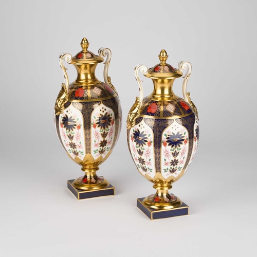 817 - A LARGE PAIR OF ROYAL CROWN DERBY OLD IMARI VASES AND COVERS the ovoid bodies with scroll handles an... 