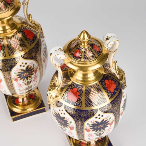 817 - A LARGE PAIR OF ROYAL CROWN DERBY OLD IMARI VASES AND COVERS the ovoid bodies with scroll handles an... 