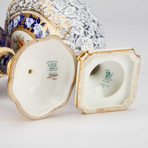 828 - TWO COALPORT VASES the first with rams head handles and a domed cover, painted with a floral medalli... 