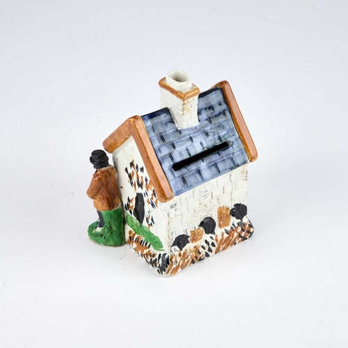 830 - A PRATT WARE MODEL OF A HOUSE modelled as a simple cottage, with figures to either side, decorated i... 