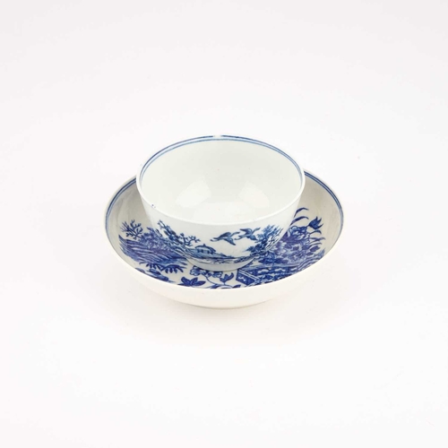 831 - A WORCESTER BLUE AND WHITE TEA BOWL AND SAUCER, CIRCA 1780 decorated with the Fence pattern, crescen... 