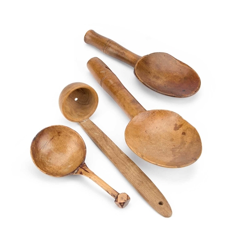 85 - THREE TREEN SPOONS AND A DIPPING STRAINER comprising an early 19th Century butter spoon, a 19th Cent... 