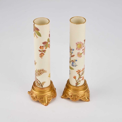 868 - A PAIR OF ROYAL WORCESTER VASES cylindrical with gilded moulded bases, the cylindrical stems decorat... 