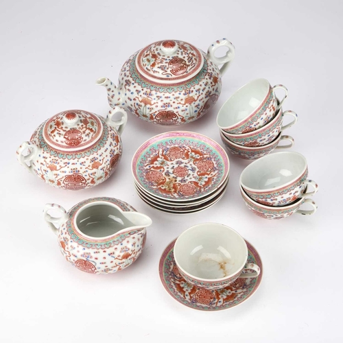 885 - A CHINESE PORCELAIN TEA SERVICE comprising a teapot, cream jug, sucrier, six cups and saucers, each ... 